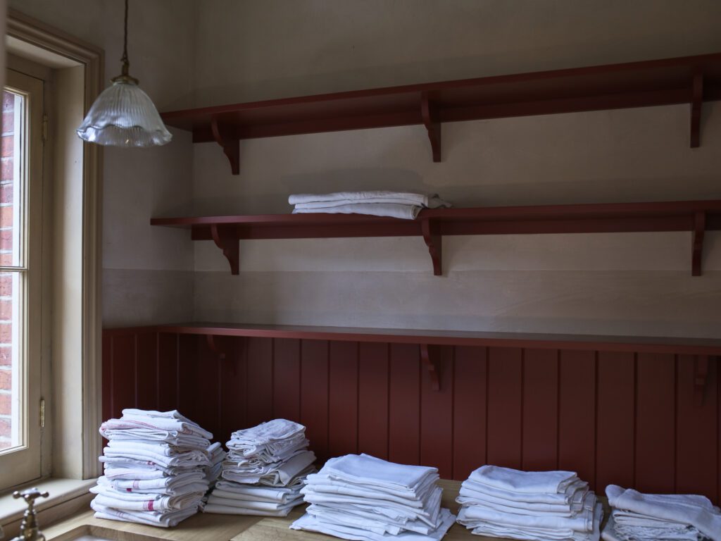 Rustic Red shelves with dinner napkins neatly folded