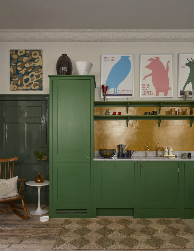 Tall and floor cupboards in bespoke room with pickle green paint and playful art